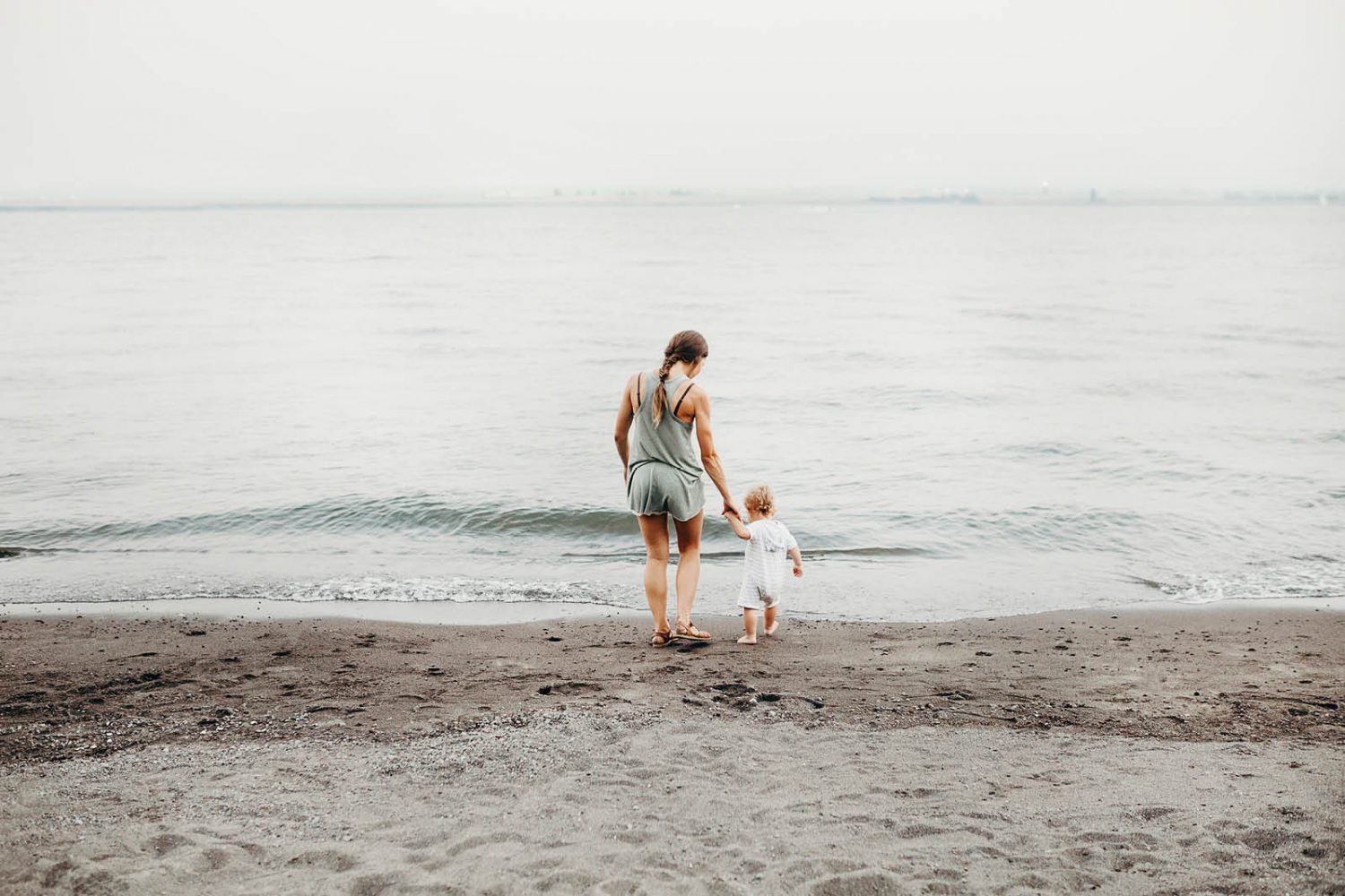 A mum with her toddler at the beach
