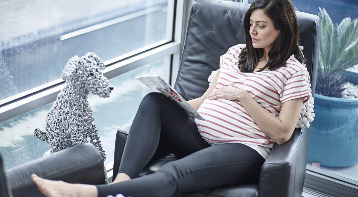 Pregnant women relaxing on couch