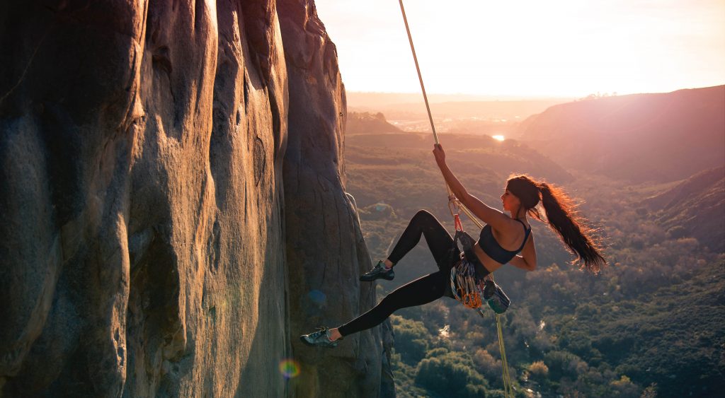Strong woman abseiling