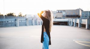 boost your confidence Woman with glowing skin and hair standing in sun