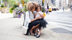 mum guilt mama disrupt Working mum with child on street