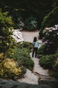 Young girl exploring in garden