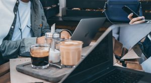 Couple working with laptops at cafe
