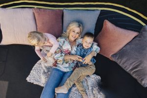 Mum relaxing on trampoline with children