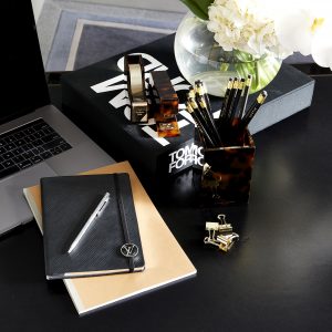 Laptop and notebooks on office desk