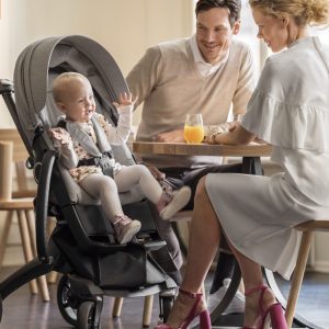 Mum and dad having breakfast with baby in Mum and baby with Stokke Xplory 6