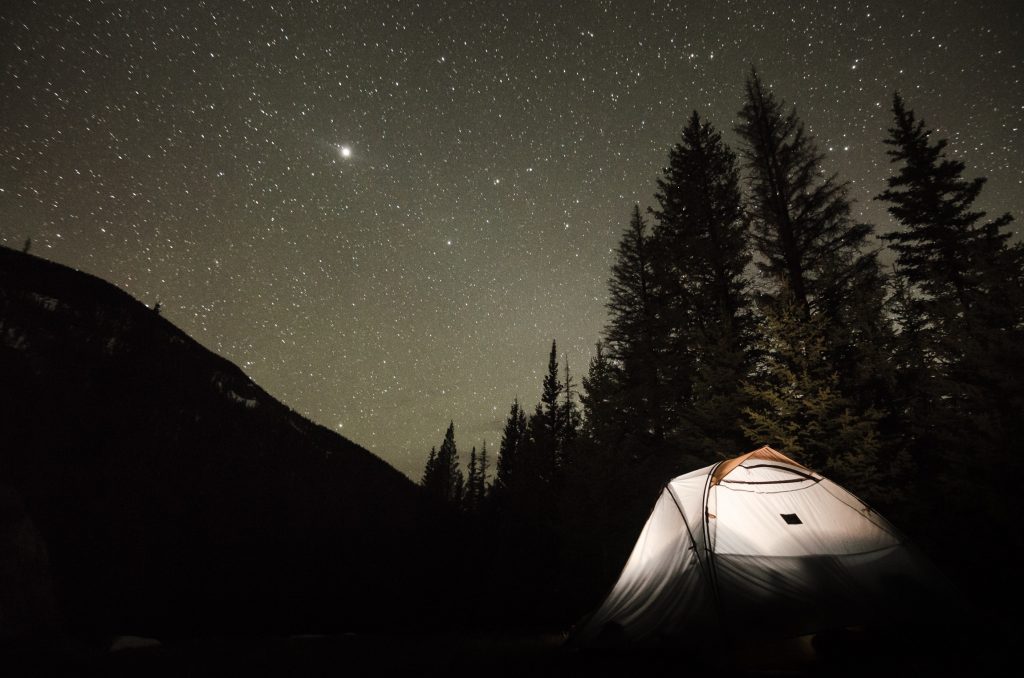 Camping tent set up under stars