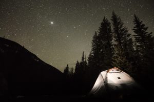 Camping tent set up under stars