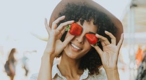 Beautiful healthy woman with strawberries