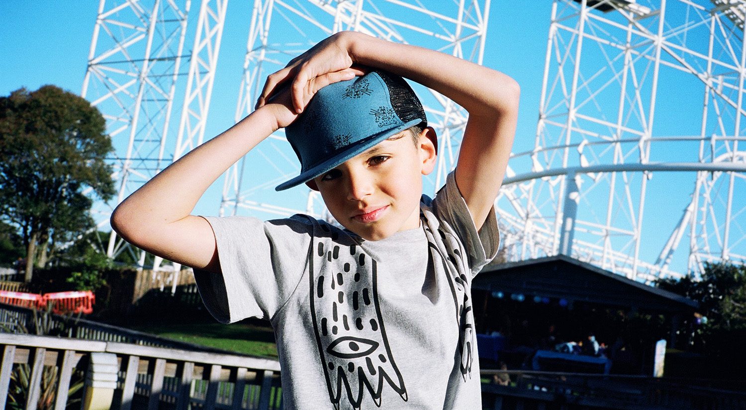 Boy at theme park wearing Band of Boys clothes
