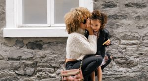 Mother whispering to daughter child