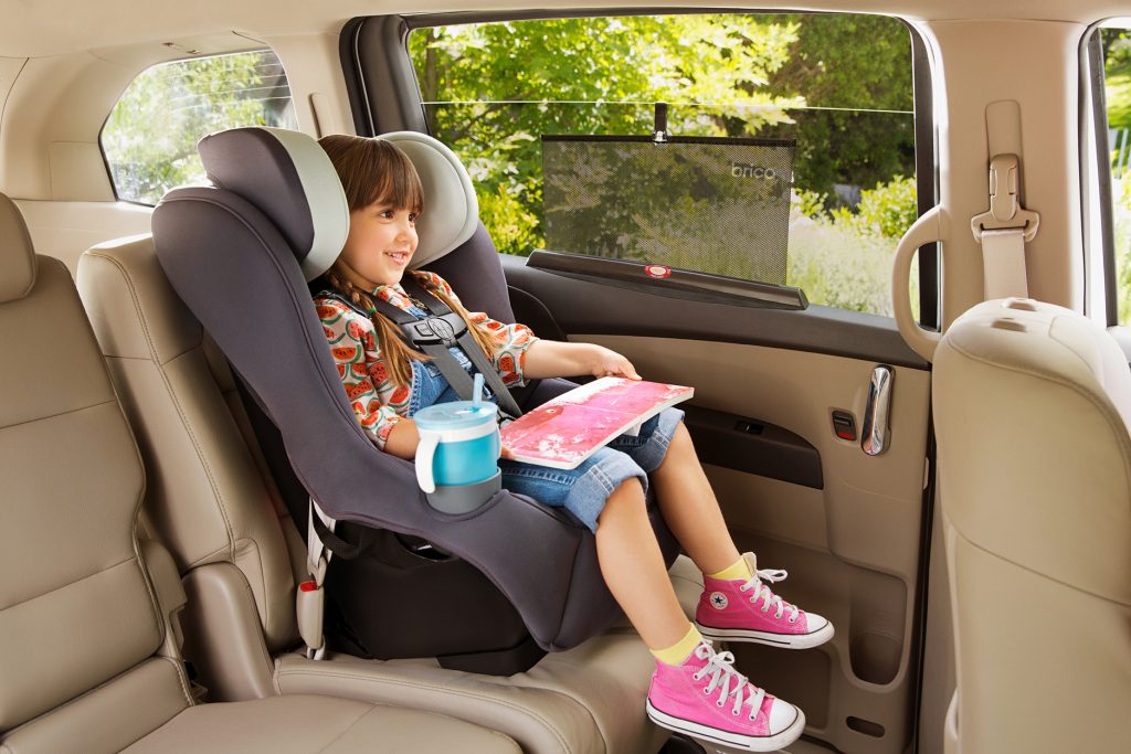Girl in car seat with Brica by Munchkin sun shade on window