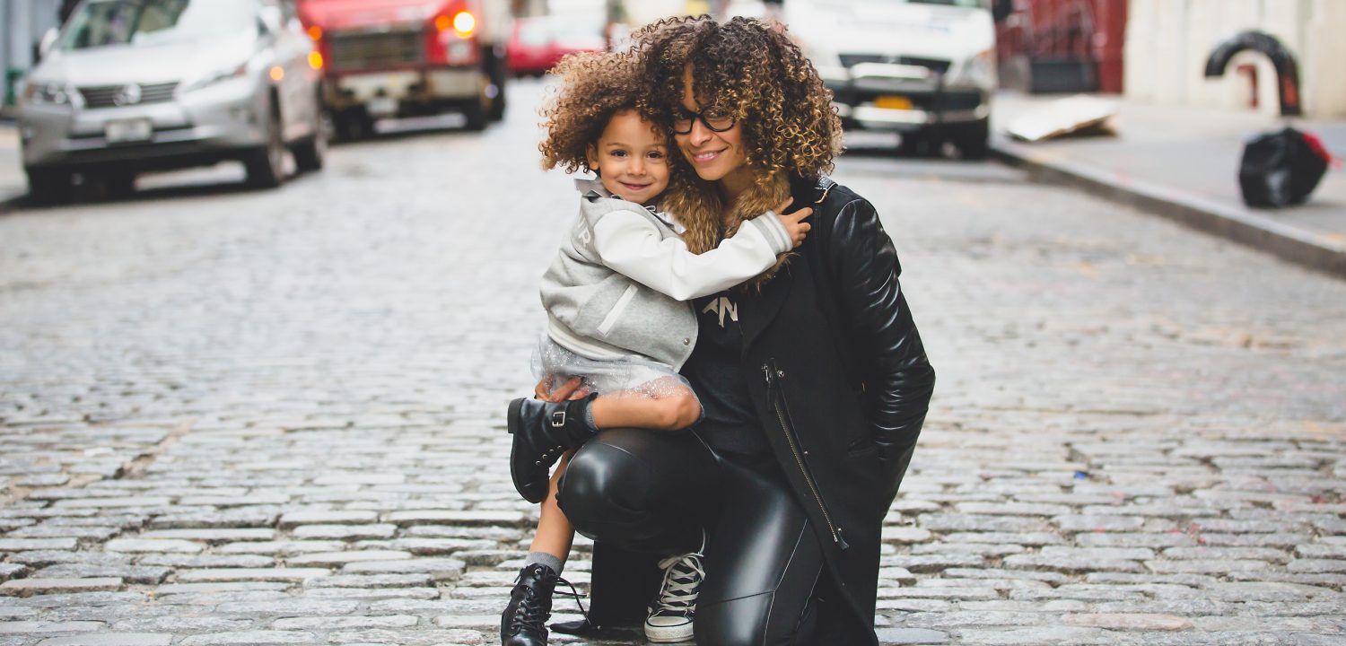 Trendy mum and daughter on road