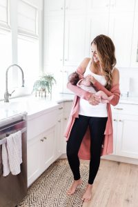 Mother nursing baby wearing Blanqi leggings and top