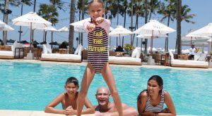 Miachel Klim with kids in swimming pool