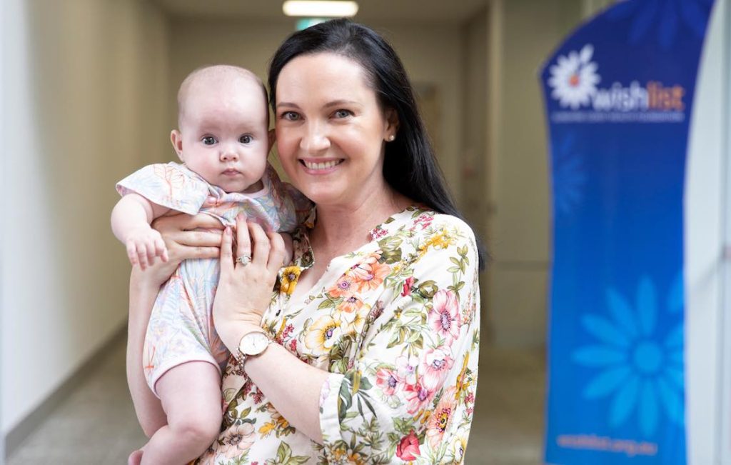 Smiling mum with baby