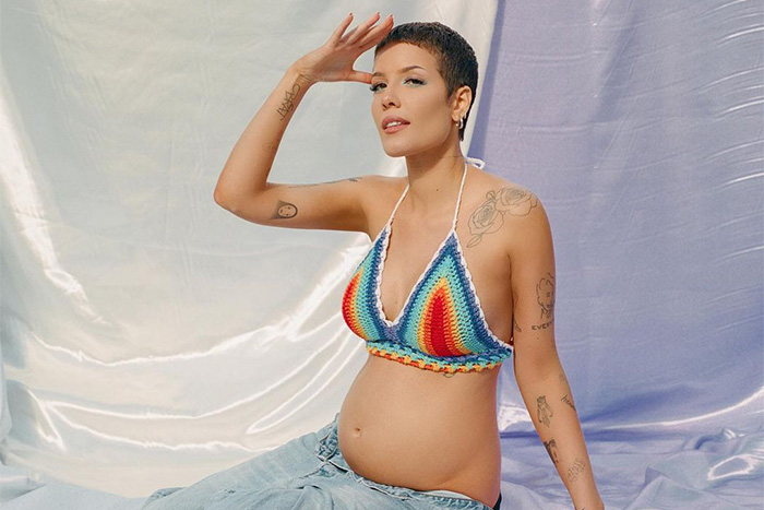 Pregnant Halsey wearing a rainbow bralette