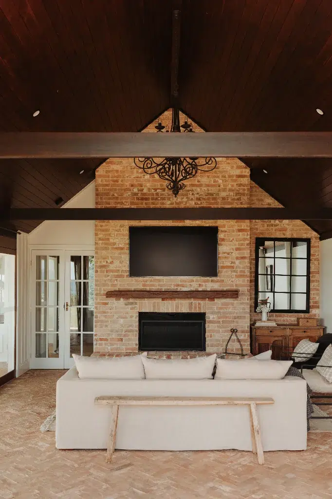 The Gatehouse exterior with pool, lounge chairs and rolling hills beyond