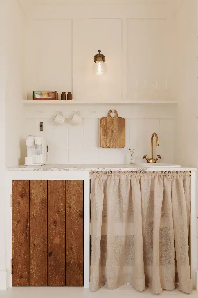 The Gatehouse bedroom with ticking stripe headboard and linen bedding