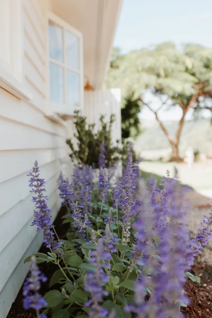 The Gatehouse Farmhouse living area with floor-to-ceiling brick fireplace and vaulted timber ceiling