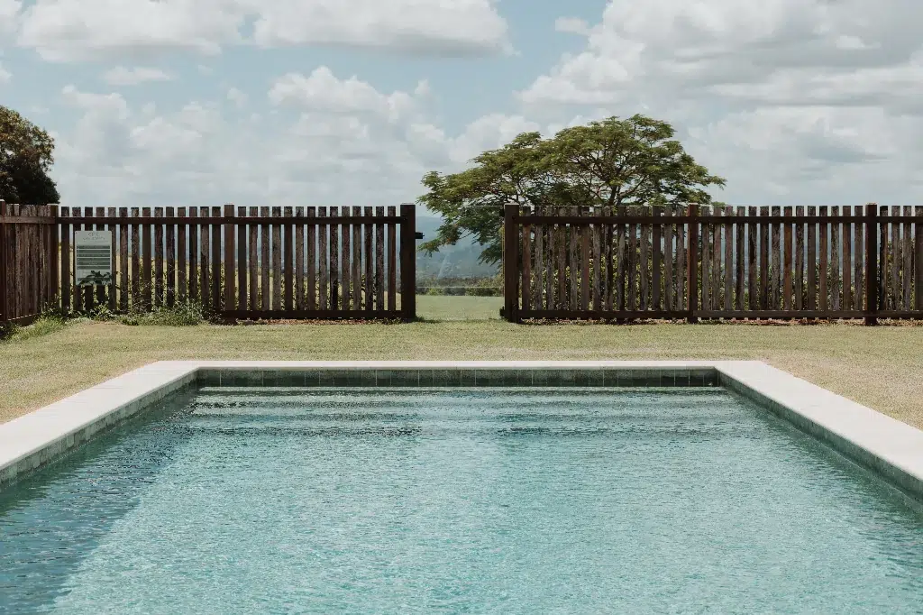 The Gatehouse kitchen with farmhouse sink, marble countertops and exposed brick